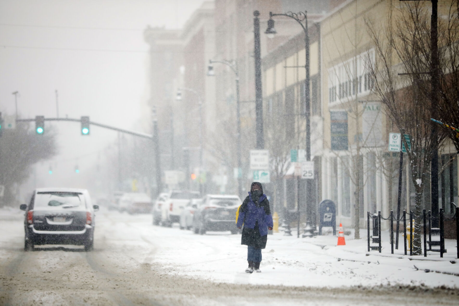 person walking in street in snow